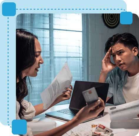 Couple discussing finances with documents and laptop, available at New Jersey Mediation Services.